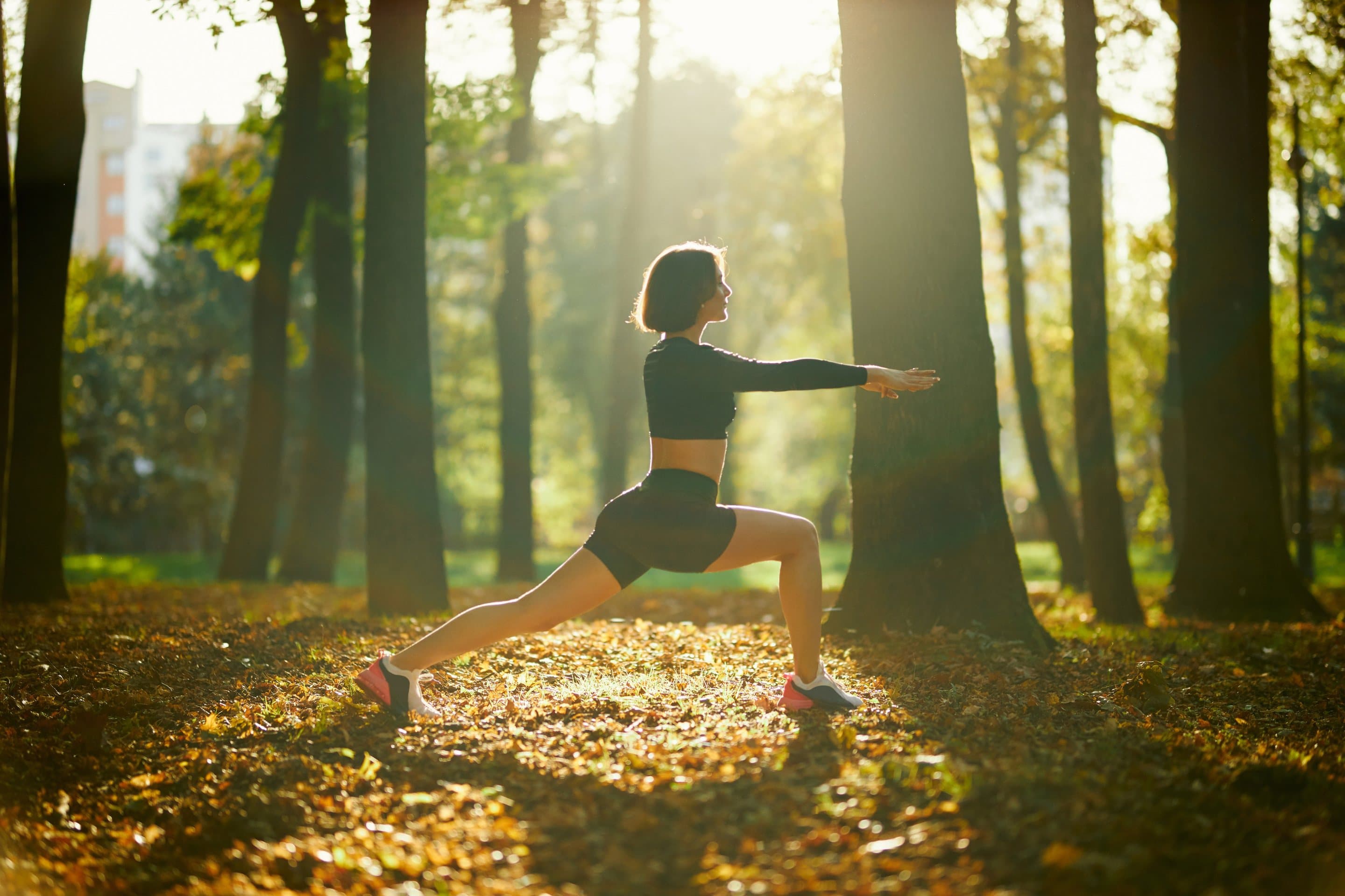 Woman practising yoga in a forest